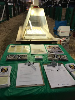 South Jersey Quail Project literature on a green tablecloth, in the background is an intubator.